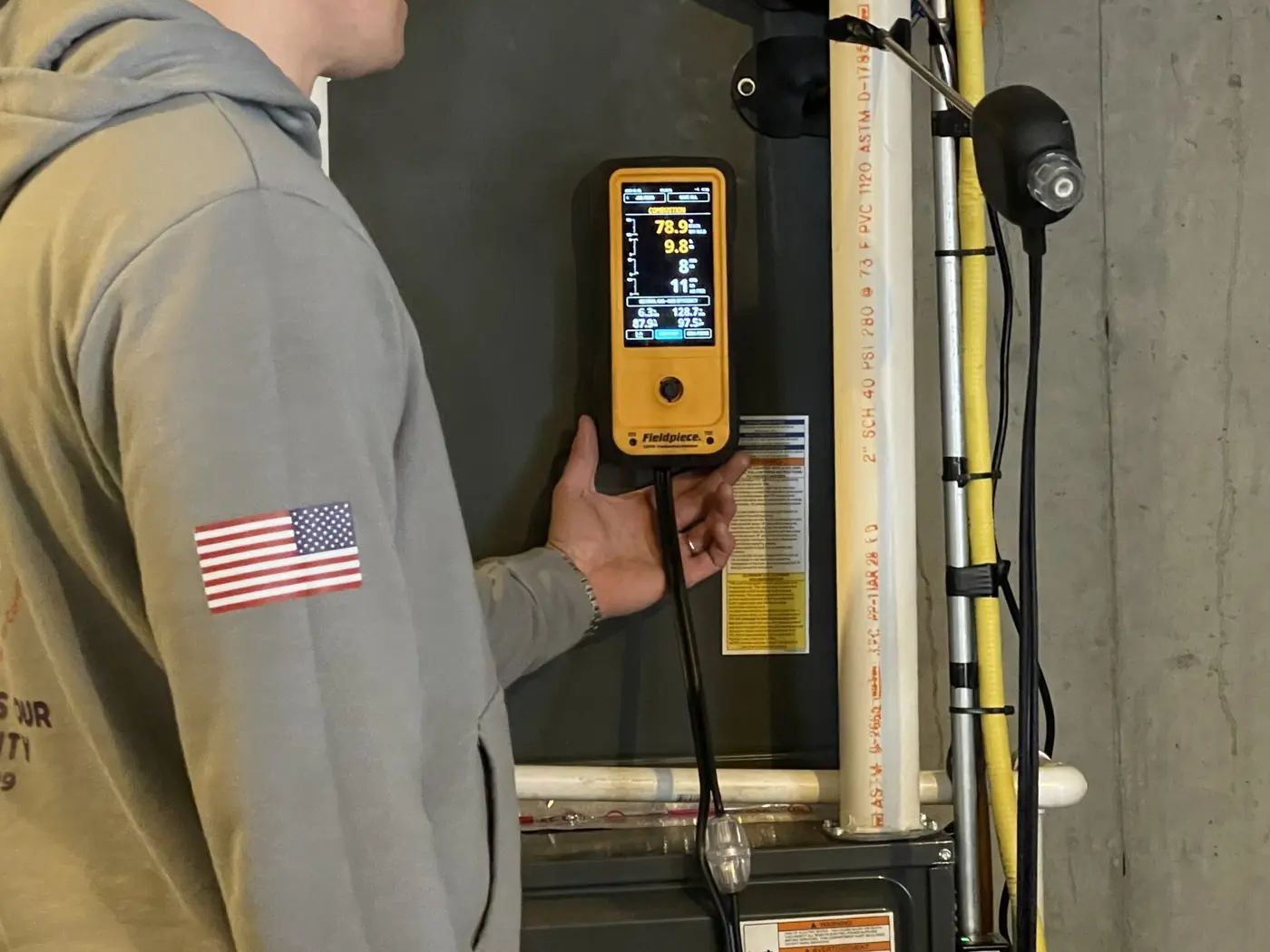 Metro HVAC technician using digital instruments during system commissioning