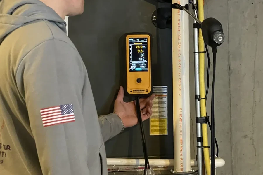 Metro HVAC technician checking residential HVAC system performance