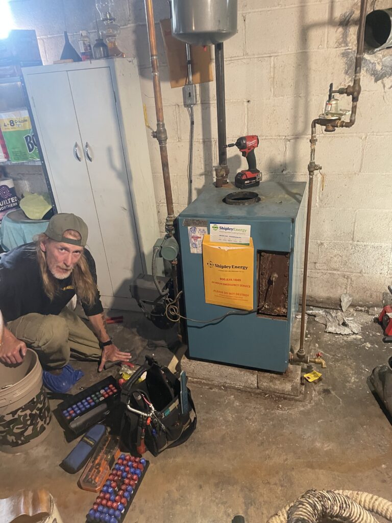 Oil Boiler Service in Camp Hill, PA: A Recent Metro HVAC Service Call 2 Metro HVAC technician and tools beside an oil boiler opened for service in Camp Hill, Pennsylvania.