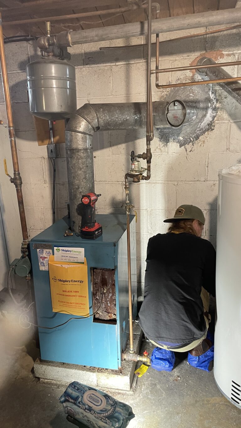 Oil Boiler Service in Camp Hill, PA: A Recent Metro HVAC Service Call 1 Metro HVAC technician working beside an oil boiler during a service call in Camp Hill, PA.