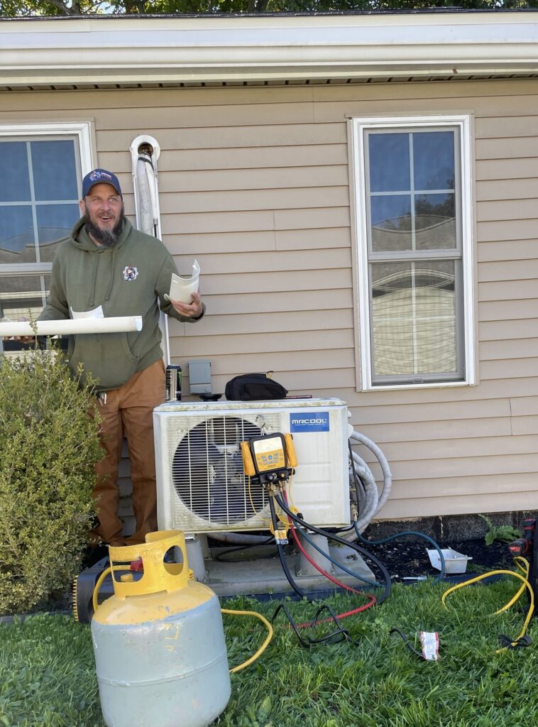 Undersized mini split being removed by Metro HVAC in Camp Hill, PA, with refrigerant recovery gauges connected